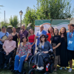 Autoridades y junta directiva de ASPAYM CyL posan durante la inauguración del campamento